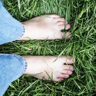 Standing barefoot in soft delightful grass 