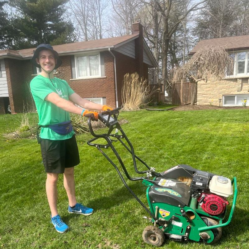 Optimism Aeration technician smiling with his aerator